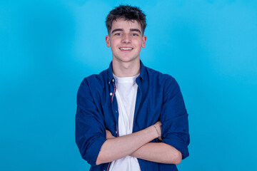 teen boy isolated on blue background © carballo