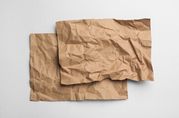 Sheets of brown paper on white background, top view