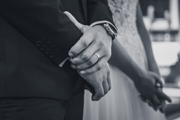 groom's hand wearing wedding ring right after the wedding ceremony