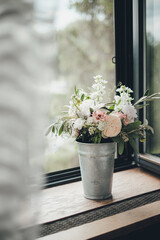 Fototapeta na wymiar wedding bouquet of live flowers in a vase placed on a window sill
