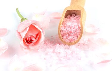 rose salt with rose petals on white background top view.