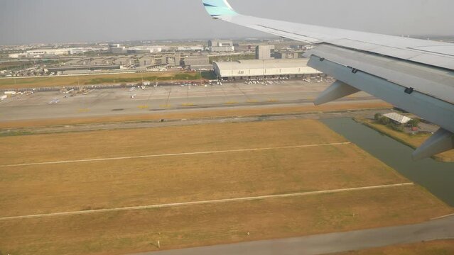 sunny day aircraft window pov panorama landing at bangkok city 4k thailand