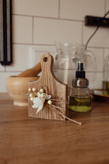 A cute rustic wooden kitchenware in the kitchen. Cozy way to rest, home comfort concept. 