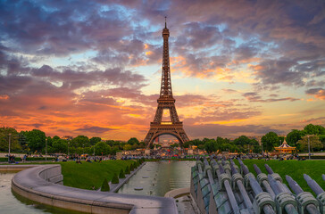 Sunset view of Eiffel Tower from fountain in Jardins du Trocadero in Paris, France. Eiffel Tower is...
