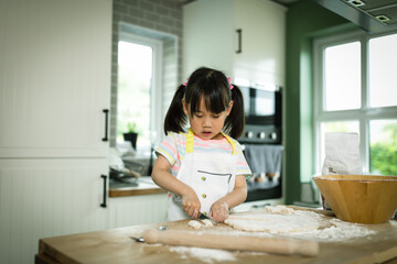 Fototapeta na wymiar young girl making bread dough at home kitchen for home schooling