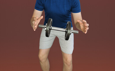 Dumbbell hanging in the air between the hands of a sports guy. Levitating dumbbell. Dumbbell in the air between the hands