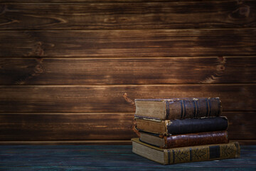 Old books on wooden shelf. Bookshelf history theme grunge background.