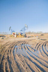 Fototapeta premium Oil pump on the background of blue sky