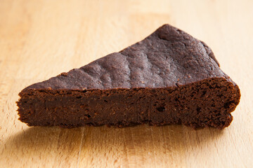 delicious chocolate cake resting on a wooden cutting board
