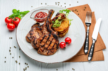 Pork steak with bone and potato pancakes