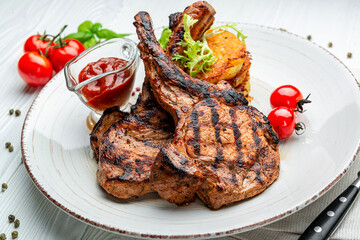 Pork steak with bone and potato pancakes