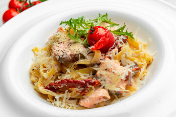 Italian pasta with salmon, cheese and tomatoes