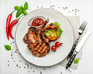 Pork steak with bone and potato pancakes