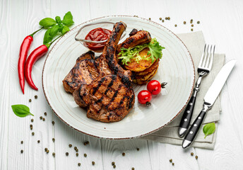 Pork steak with bone and potato pancakes