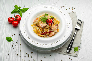 Italian pasta with salmon, cheese and tomatoes