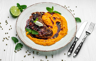 Duck fillet in cherry sauce with pumpkin puree