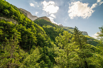 Views of the mountain and the forest with sunbeams in the Ordesa and Monte Perdido National Park.
