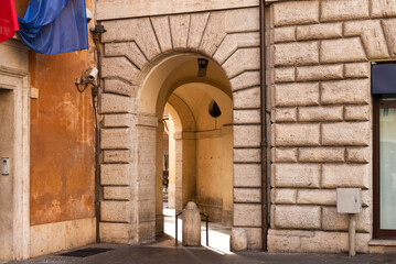 The arch between the streets in Rome. The corner passage under the house is blocked by a concrete pillar.