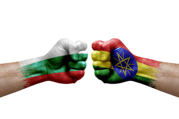 Two hands punch to each others on white background. Country flags painted fists, conflict crisis concept between bulgaria and ethiopia