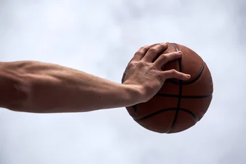 Fotobehang man holding a basketball © Oscar