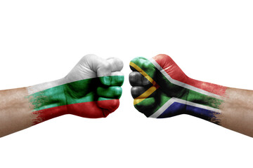 Two hands punch to each others on white background. Country flags painted fists, conflict crisis concept between bulgaria and south africa