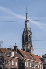 Fototapeta na wymiar View of XV century Belfry of Nieuwe Kerk (New Church, 1396 - 1496) on Market square in Delft. New Church, with 108,5 m church tower - second highest church in the Netherlands. Delft.