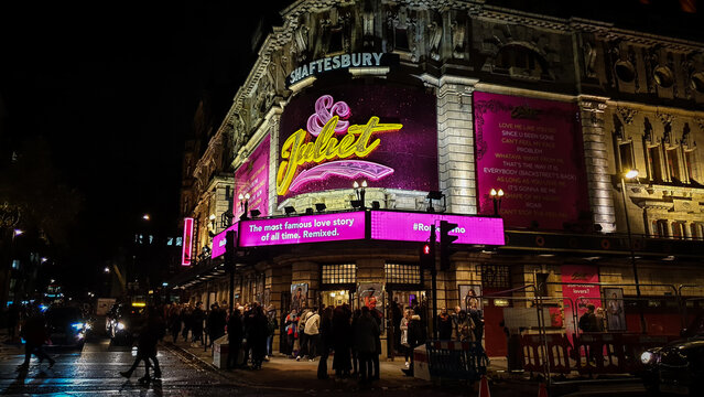 London, UK - 11.05.2019: "And Juliet" musical play neon sign at night. People leaving Shaftesbury theatre after the show. London culture and entertainment life in the evening.