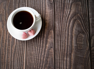 Mug of beverage with pink chocolate hearts