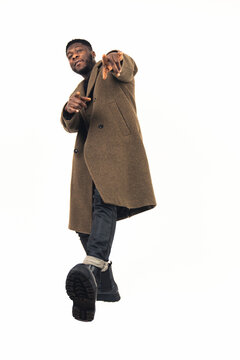 male model of color relaxed standing in one-foot white background - full shot. High-quality photo