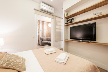 open plan kitchen with white cabinets and table with high stools in vacation rental apartment