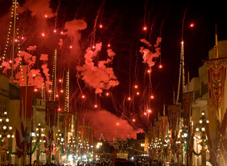 Flares Descend over a decorated village feast in Zurrieq in Malta