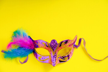 Carnival mask on yellow background. Mardi Gras concept. Fat Tuesday symbol.