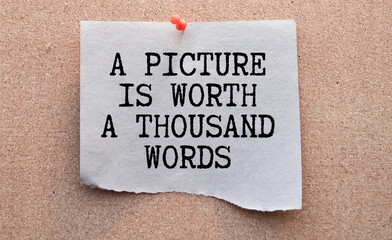 A picture is worth a thousand words Message. Recycled paper note pinned on cork board