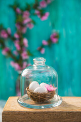 Obraz na płótnie Canvas Spring blossom, Easter concept, miniature bunny, flowering tree close-up and copy space. Pink natural texture of natural flowering tree. Easter egg and branches of blossoming on an table..