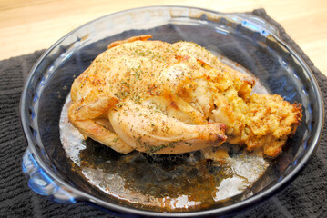 A Plated Whole Roasted Game Hen in a Baking Dish