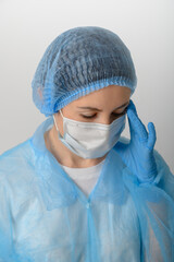 Doctor or nurse in a medical gown, mask and protective gloves