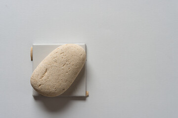 two objects made of natural materials (ceramic tile, brick stone)