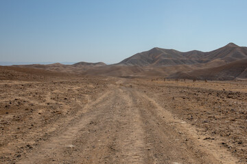 Beautiful landscape of Israeli Judean Desert mountains, with sunrise over the dry riverbed of Nahal...
