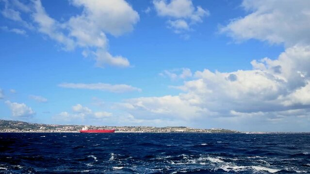 a cargo ship crosses the Messina strait in the mediterranean sea