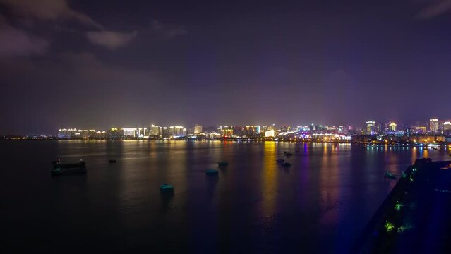 sanya city bay night illuminated famous hotel resort rooftop panorama timelapse 4k hainan island china