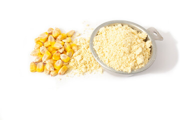 Organic Cornmeal in Vintage Measuring Cup with Whole Kernel Corn in Small Pile Isolated on White