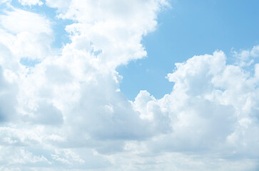 White air cumulus clouds in a blue sky. Summer background