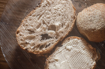 artisan bread with butter and fried egg, on a transparent plate, copy space on the left