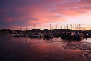 Fototapeta premium romantic pink sunset over the sea waters of the port of san antonio in ibiza
