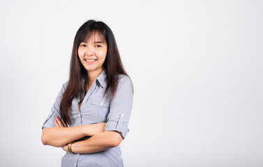 Woman standing her smile confidence with crossed arms isolated white background, Asian happy portrait beautiful young Thai female looking to camera in studio shot on white background and copy space