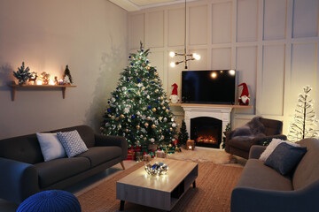 Cozy living room interior with beautiful Christmas tree near fireplace