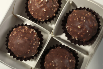 Many delicious chocolate candies in box, top view