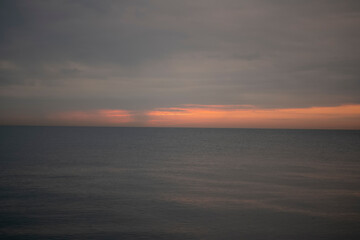 Evening orange sunset over a calm sea in summer.