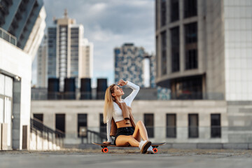 Sexy girl sitting on a skateboard.