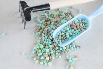 Chemical fertilizers are in wooden baskets with plants placed on a white background. Concept...